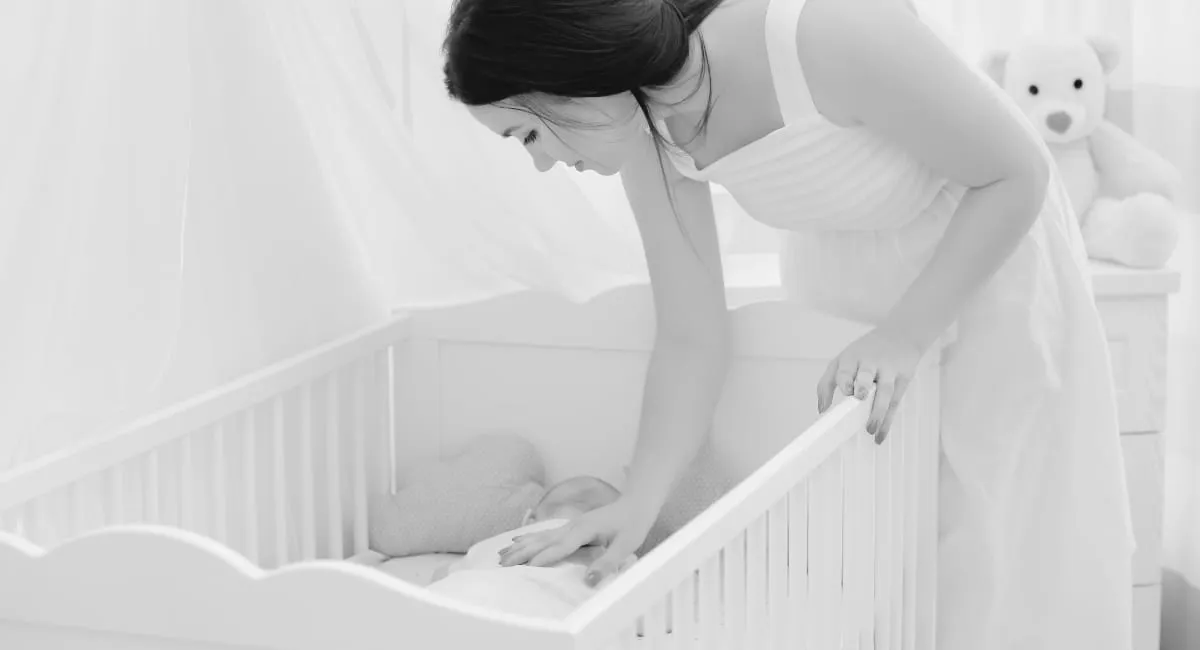 Parent with baby at dawn, learning how to stop baby waking early