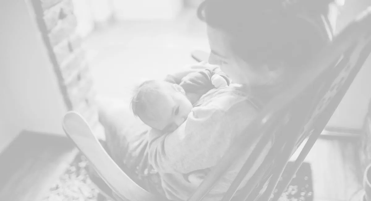 mum rocking baby to sleep